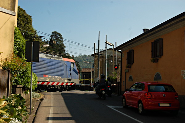[Un treno merci trainato da una Re 474 di SBB Cargo impegna il
passaggio a livello sulla provinciale per Varese a Laveno (Laveno, 22
aprile 2017)]