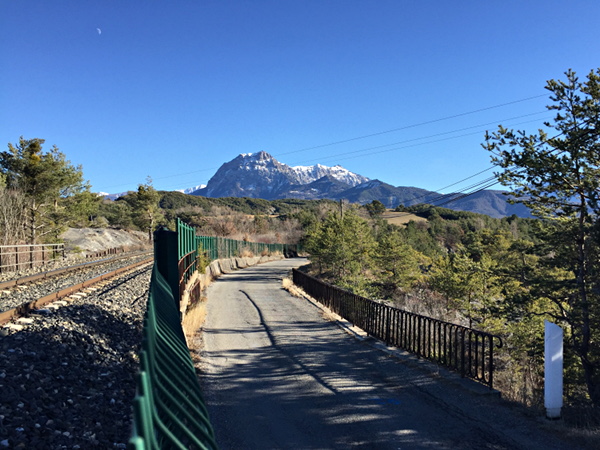 [Strada per la baia di  Chanteloube, ricavata dal vecchio sedime della
ferrovia  Gap-Briançon.   Sulla  sinistra   si  vede  la  variante  di
tracciato inaugurata nel 1960.  Chorges, 14 gennaio 2019.]